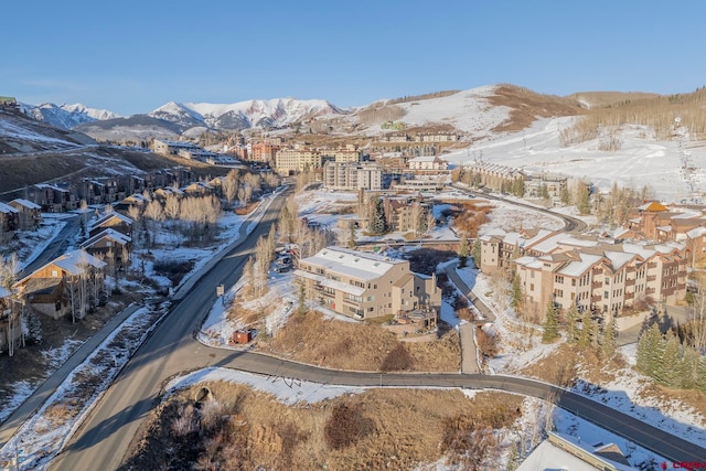 snowy aerial view featuring a mountain view