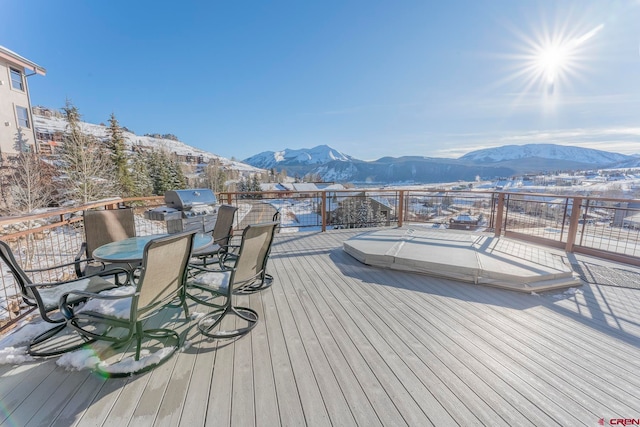 wooden terrace featuring a mountain view and a grill