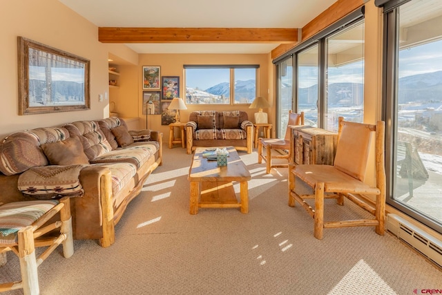 living room with beamed ceiling, a mountain view, light carpet, and a baseboard heating unit