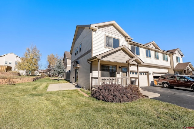 view of front of home featuring a porch, a garage, and a front yard