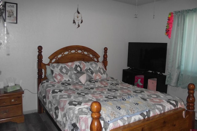 bedroom with dark wood-type flooring