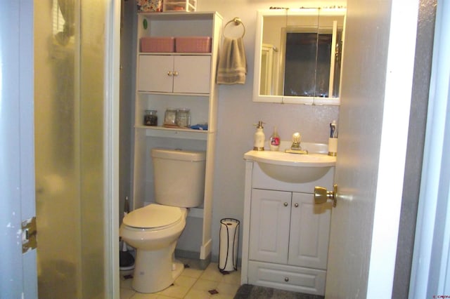 bathroom featuring tile patterned floors, vanity, and toilet