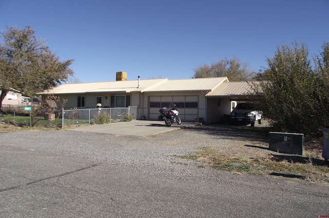 single story home featuring a carport and a garage