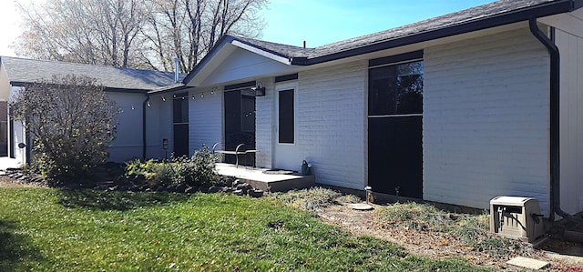 entrance to property with a lawn