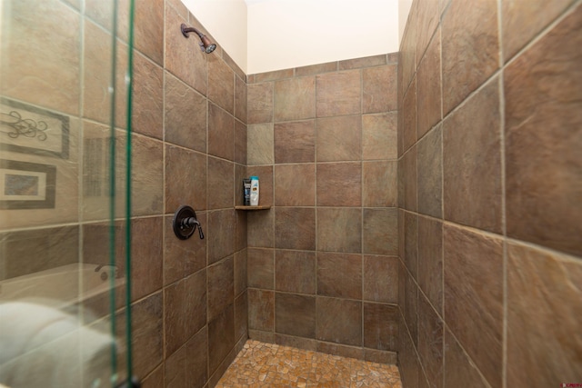 bathroom with tiled shower