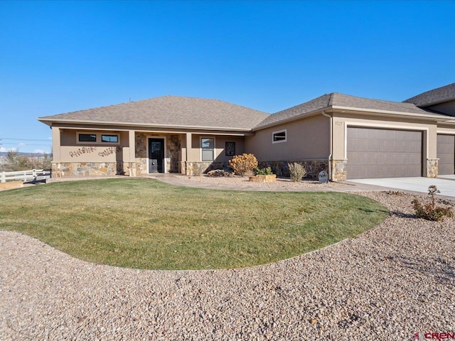 view of front of home featuring a front yard and a garage