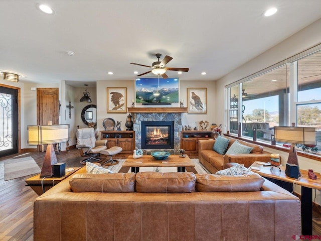 living room featuring a fireplace, ceiling fan, and hardwood / wood-style floors