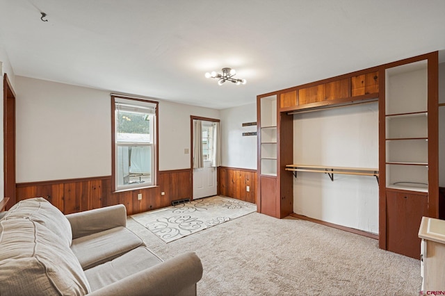 carpeted living room with a chandelier