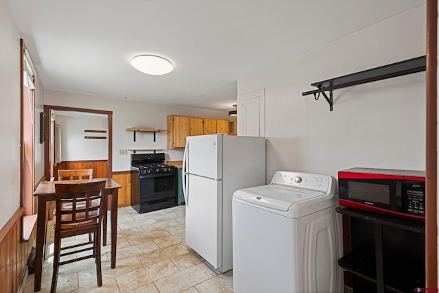 washroom with wooden walls and washer / dryer