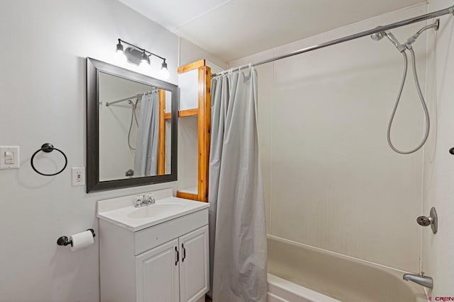 bathroom featuring shower / bath combo with shower curtain and vanity