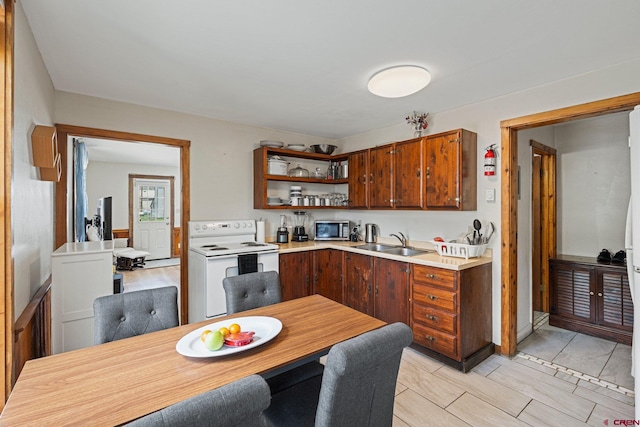 kitchen featuring sink and white electric range