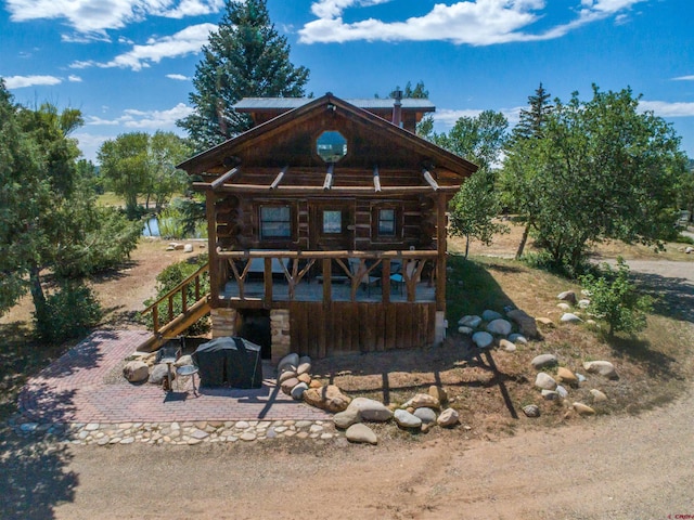 log cabin with a patio area