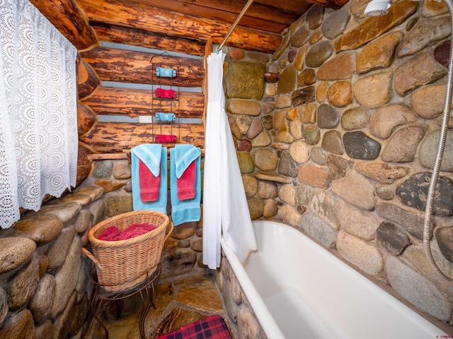 bathroom with shower / bath combo with shower curtain