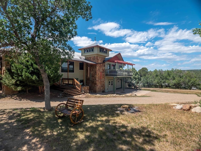 rear view of property with a patio and a lawn