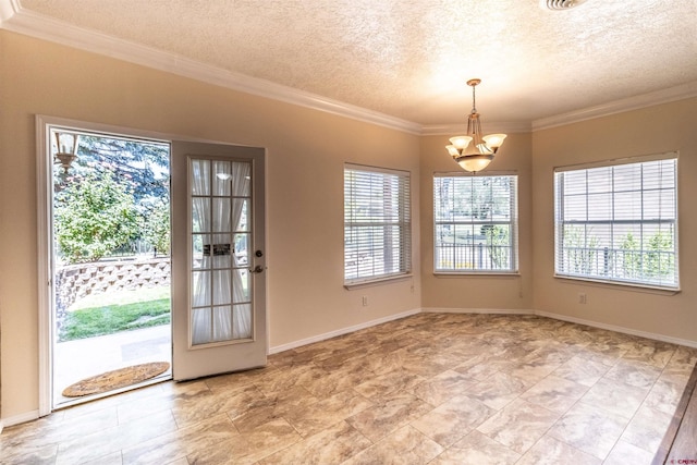 interior space with a textured ceiling, an inviting chandelier, and ornamental molding