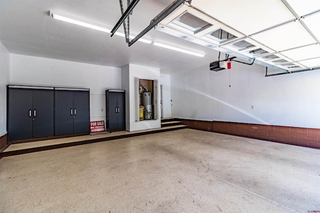 garage with a garage door opener and gas water heater