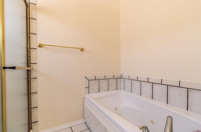 bathroom with tile patterned floors and a washtub