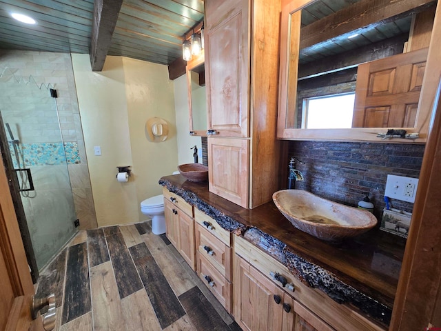 bathroom featuring wooden ceiling, walk in shower, beamed ceiling, vanity, and hardwood / wood-style flooring