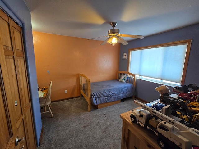 unfurnished bedroom featuring a closet, dark carpet, and ceiling fan