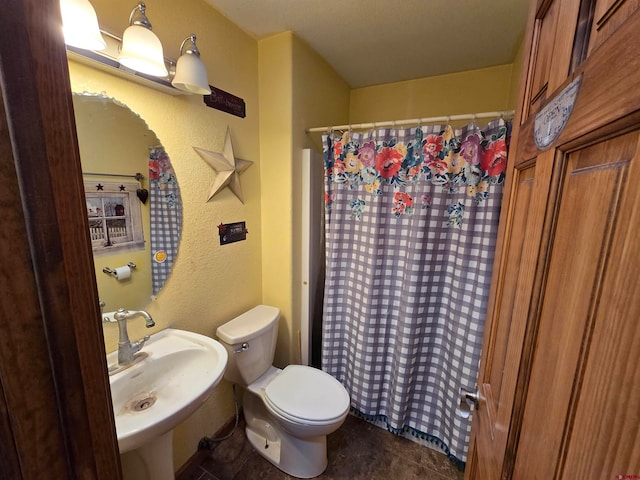 bathroom featuring sink, tile patterned flooring, and toilet