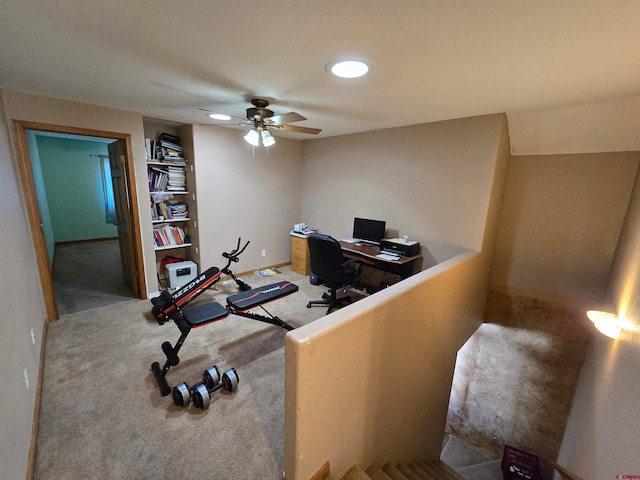 carpeted office featuring ceiling fan