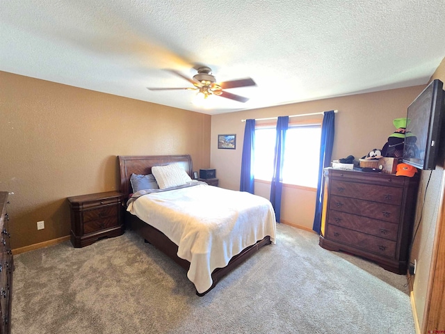 carpeted bedroom featuring a textured ceiling and ceiling fan