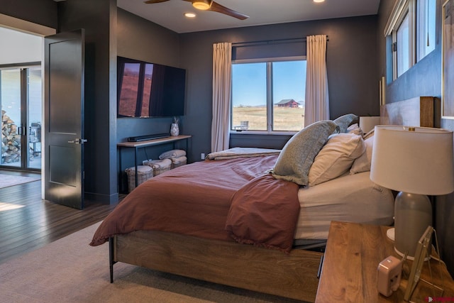 bedroom with hardwood / wood-style floors and ceiling fan