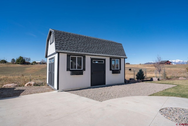 view of outbuilding with a rural view