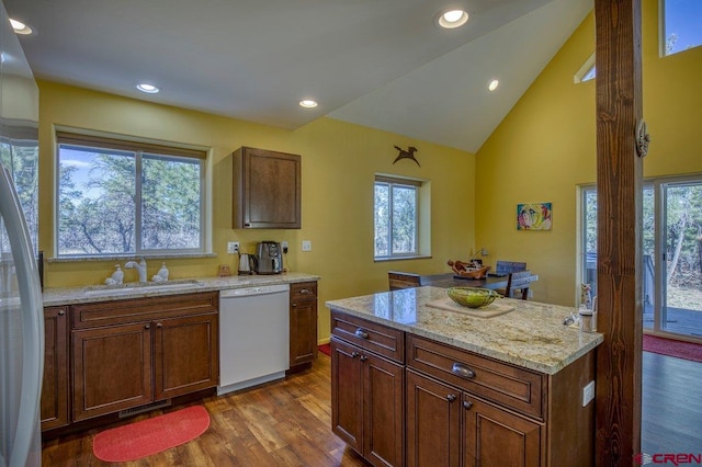 kitchen with sink, a healthy amount of sunlight, and white appliances