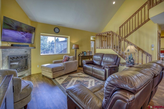 living room featuring dark hardwood / wood-style flooring and lofted ceiling