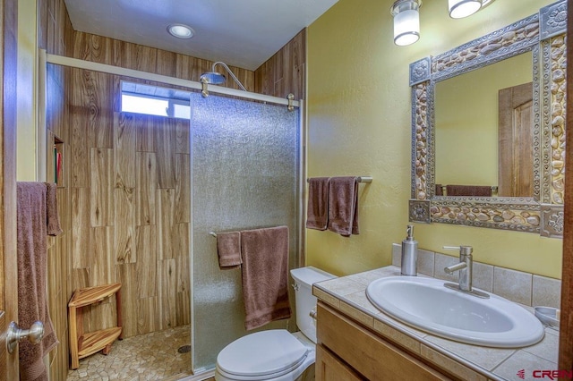 bathroom featuring an enclosed shower, vanity, and toilet