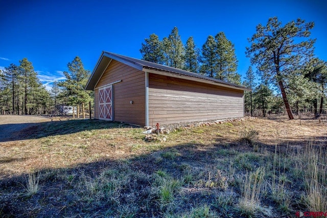 exterior space with an outdoor structure and a lawn