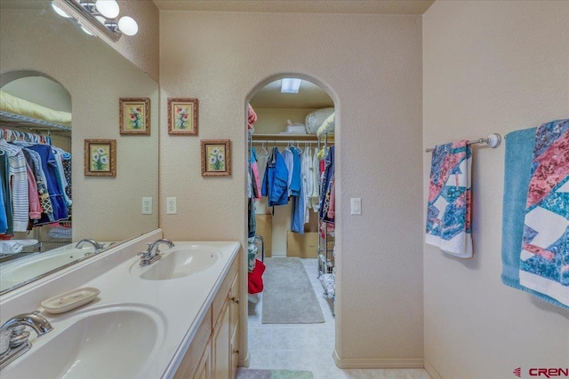 bathroom with tile patterned floors and vanity