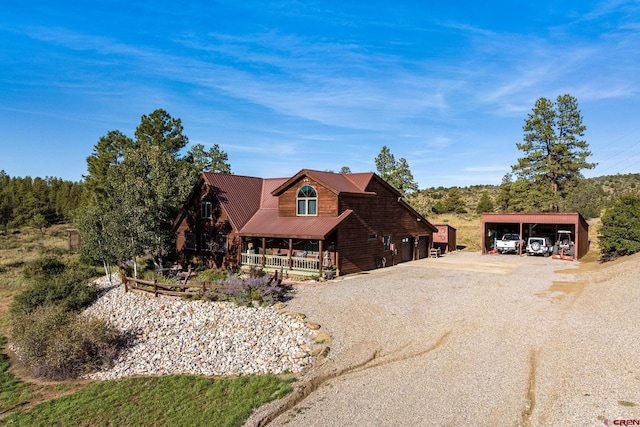 log home with a porch and a carport