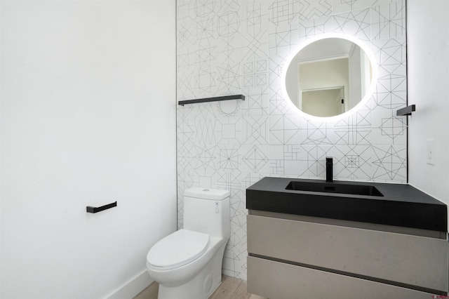 bathroom featuring tasteful backsplash, hardwood / wood-style floors, toilet, vanity, and tile walls