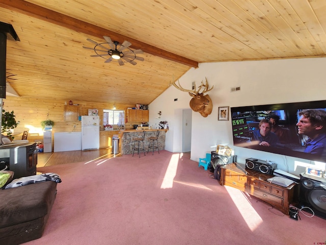 living room with a wood stove, light carpet, wooden ceiling, lofted ceiling with beams, and ceiling fan