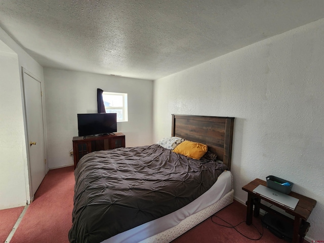 carpeted bedroom featuring a textured ceiling