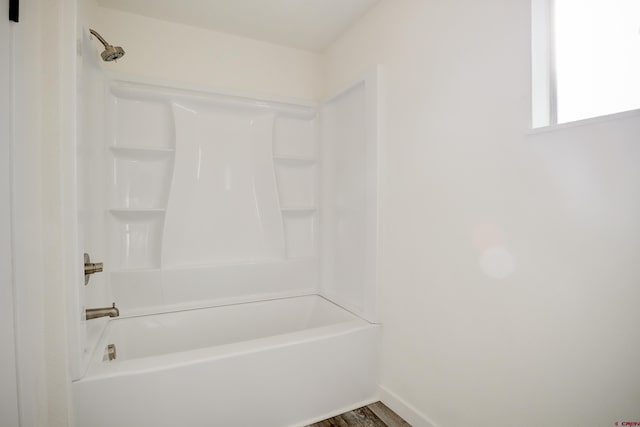 bathroom featuring hardwood / wood-style flooring and shower / bathing tub combination