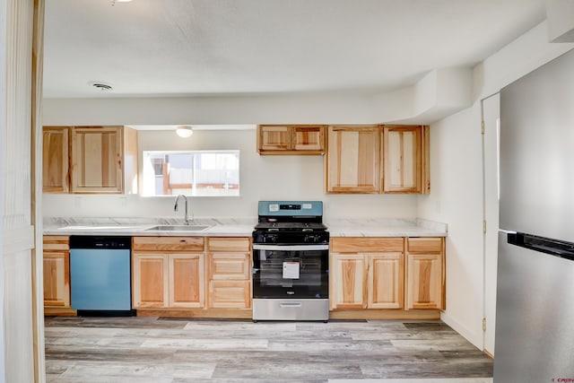 kitchen with a sink, visible vents, dishwasher, light brown cabinetry, and stainless steel range with gas stovetop