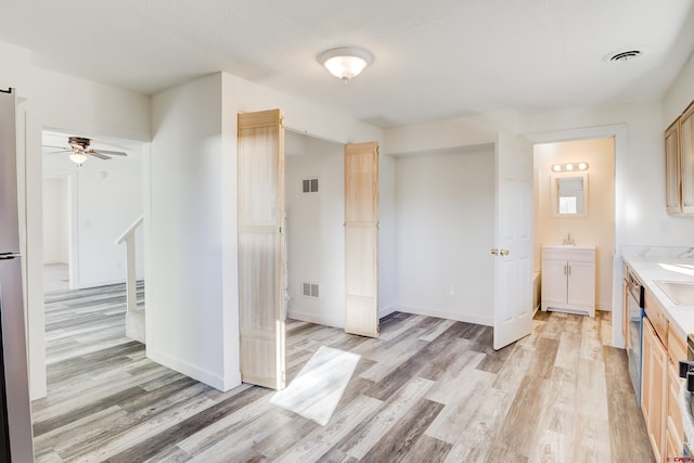 kitchen featuring ceiling fan, sink, light brown cabinetry, and light hardwood / wood-style flooring