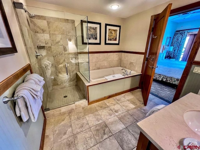 bathroom with tile patterned floors, plus walk in shower, and vanity