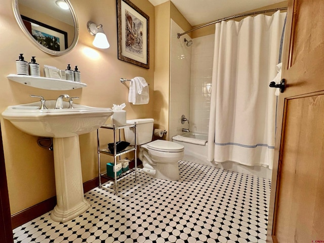 bathroom featuring toilet, shower / tub combo, and tile patterned floors