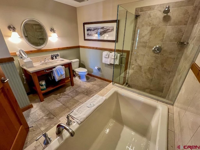 bathroom featuring tile patterned floors, vanity, toilet, and walk in shower