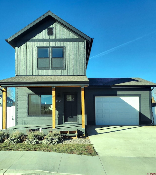 view of front of property featuring a porch and a garage