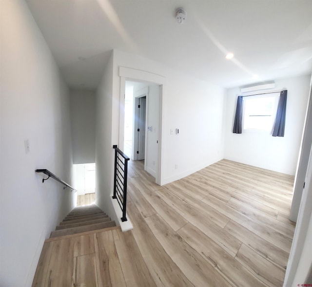 stairway with hardwood / wood-style floors