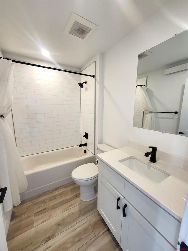 full bathroom with hardwood / wood-style flooring, vanity, toilet, and shower / bathtub combination with curtain