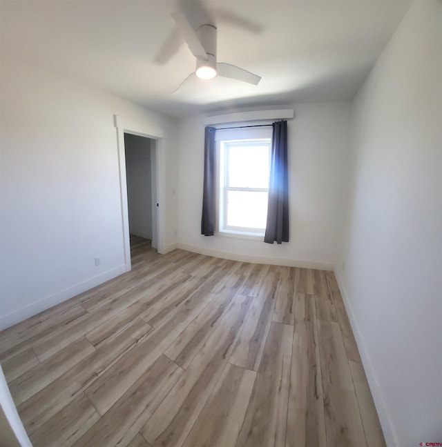 unfurnished room with ceiling fan and light hardwood / wood-style floors