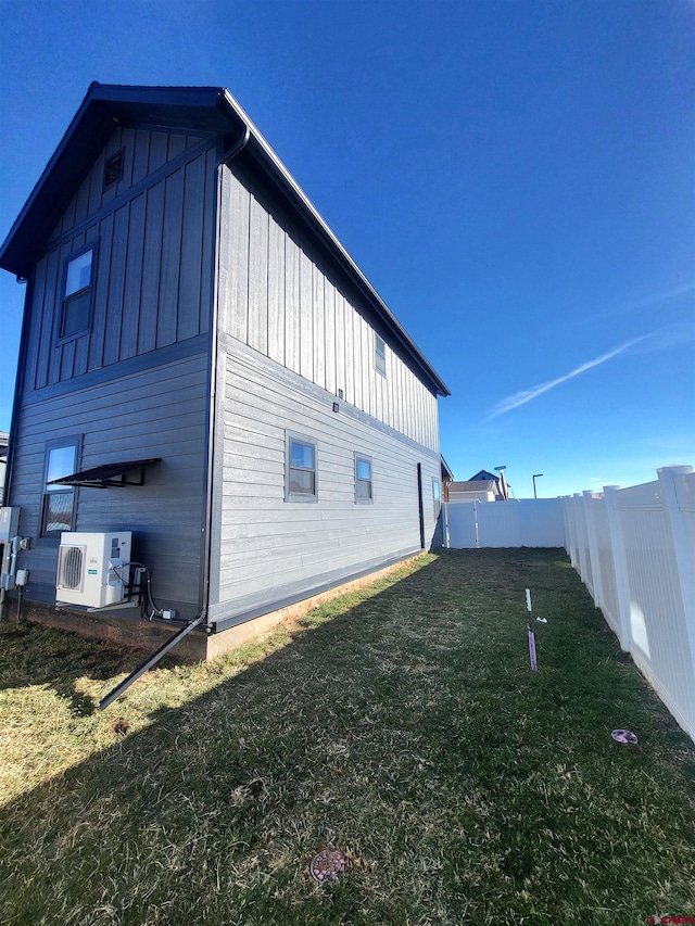 view of home's exterior with a lawn and ac unit