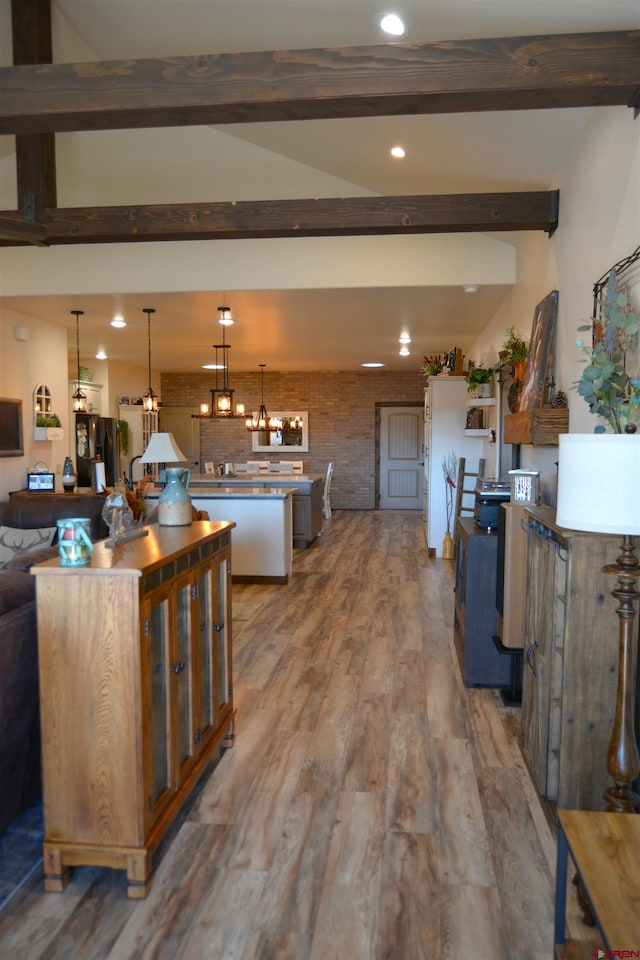 kitchen with hardwood / wood-style floors, a kitchen island, and beam ceiling