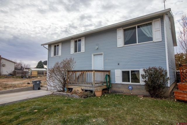 rear view of house featuring a yard